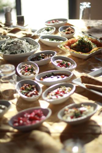 a table topped with bowls of different types of food at Bab Al Shams Resort in Jericho