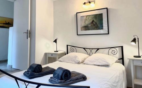 une chambre avec un lit avec deux chapeaux dessus dans l'établissement Appartement La Gravière, à Soorts-Hossegor