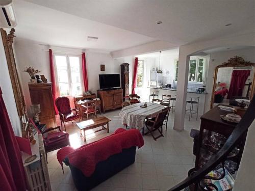a living room with a table and a living room at Villa tres proche du centre ville in Nice