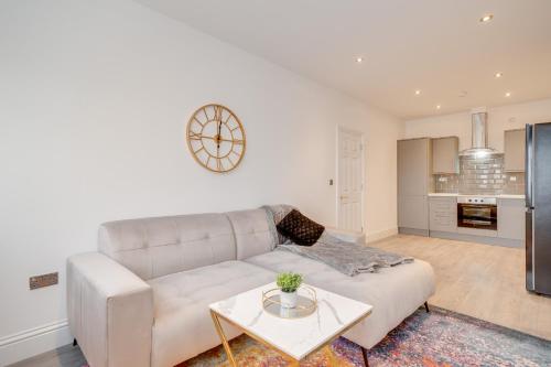 a living room with a couch and a table at Town House Apartments in Wakefield