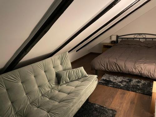 a living room with a couch and a bed at Vila s bazenom deluxe - GTI in Zagreb