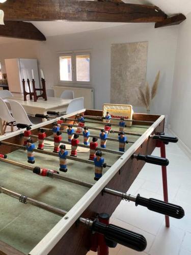 a room with a ping pong table with figurines on it at L'euphoria - Cœur historique Saumur - Château in Saumur