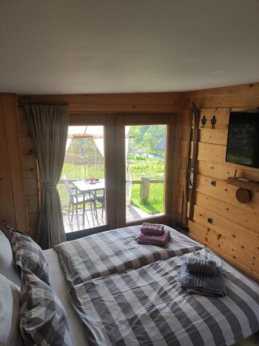 a bedroom with a bed and a large window at Vintgar studio in Bled