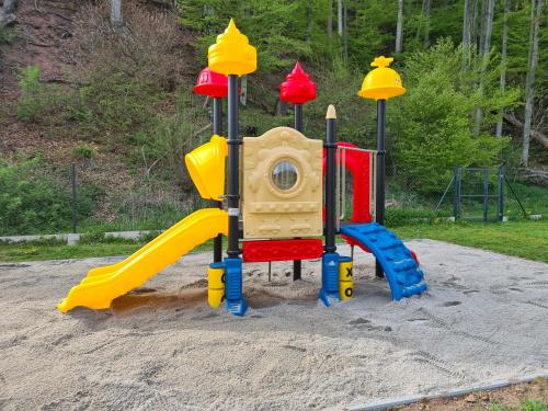a childrens playground with a play set in the sand at DOMKI POD ZIELONYM WZGÓRZEM 2 in Kudowa-Zdrój