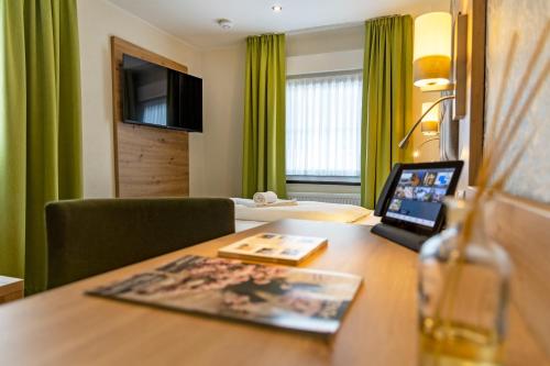 a hotel room with a desk with a laptop on it at AKZENT Hotel Restaurant Roter Ochse Rhens bei Koblenz in Rhens