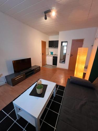 a living room with a couch and a coffee table at Apartment 1,2,3 in Osnabrück