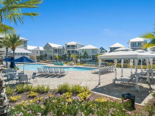 a pool at the resort with chairs and umbrellas at Prominence on 30A Pet Friendly Vacation Rentals by Panhandle Getaways in Watersound Beach