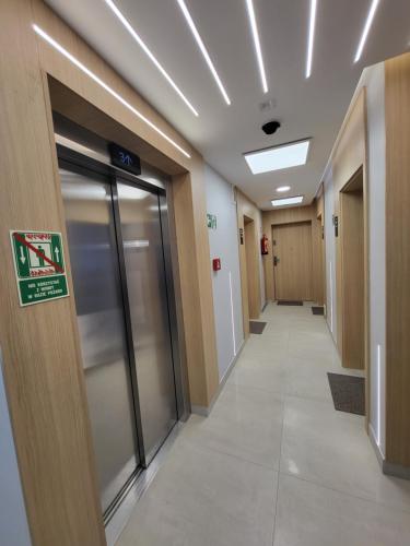 a hallway of a hospital with doors and a sign at Baltic Soul Villa in Międzyzdroje
