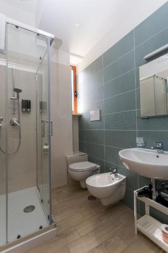 a bathroom with a shower and a toilet and a sink at AD UN PASSO DAL MARE in Praia a Mare