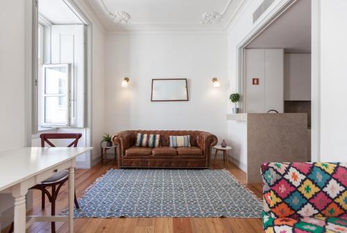 a living room with a couch and a table at FLH Lux Baixa Flat - Historical Center near Tejo River in Lisbon