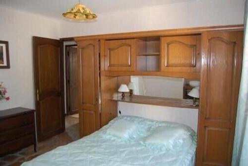 a bedroom with a bed and wooden cabinets at La Lezardière Gorges du Verdon in Régusse