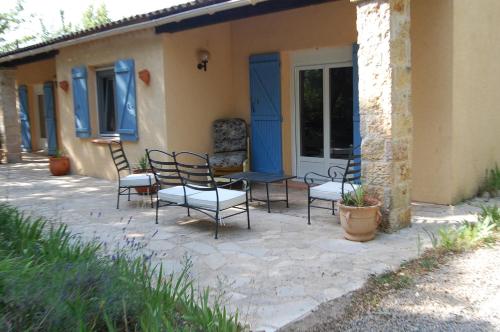 a patio with chairs and a table in front of a house at La Lezardière Gorges du Verdon in Régusse