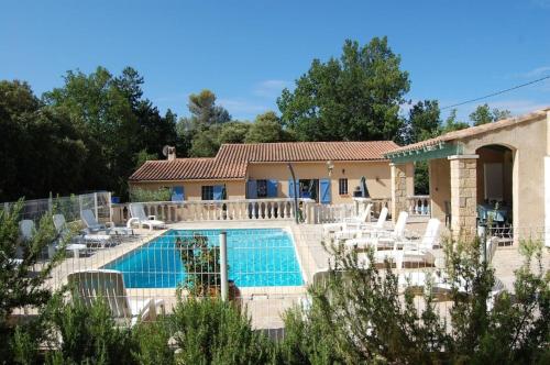 a villa with a swimming pool and chairs at La Lezardière Gorges du Verdon in Régusse