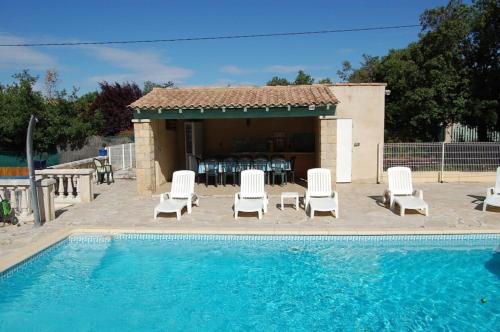 a pool with a group of chairs and a house at La Lezardière Gorges du Verdon in Régusse