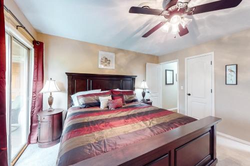a bedroom with a large bed with a ceiling fan at The Bluffs Lakeview in Branson
