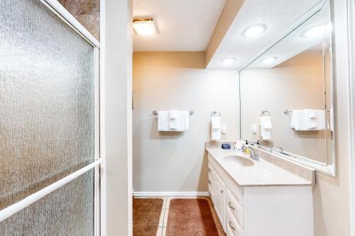 a bathroom with a shower and a sink and a mirror at The Bluffs Lakeview in Branson