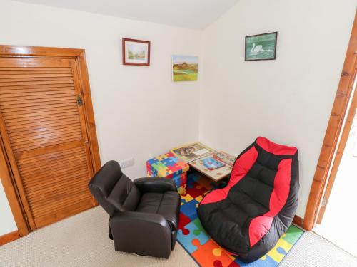 a living room with a chair and a table at Saoirse in Gortmore