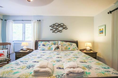 a bedroom with a bed with towels on it at Rue De Buci in Johns Island
