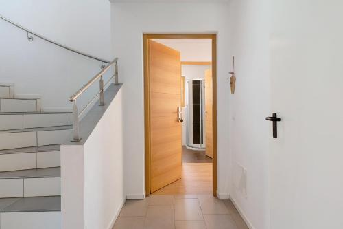 a hallway with stairs and a cross on the wall at Stiflerhof Apt Enzian in Falzes