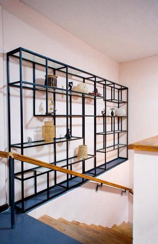 a shelf on the wall with various items on it at CITY HOTEL in Antananarivo