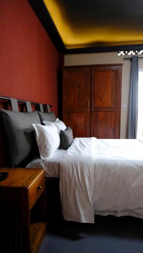 a bedroom with two beds and a yellow ceiling at CITY HOTEL in Antananarivo