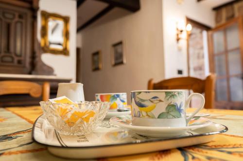 a table with a coffee cup and plates on it at La Casa de Salinas in Salinas de Pisuerga