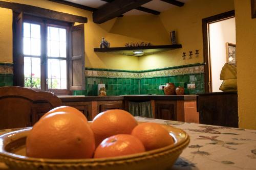 a bowl of oranges on a table in a kitchen at La Casa de Salinas in Salinas de Pisuerga
