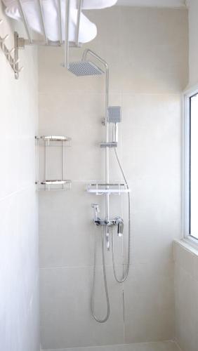 a bathroom with a shower with a shower head at CITY HOTEL in Antananarivo