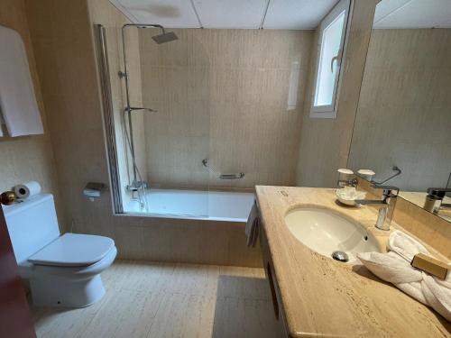a bathroom with a sink and a shower and a toilet at Apartamentos Sol Radiante in Canyamel
