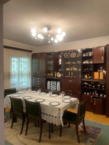 a dining room with a table and a wine cellar at Nelly's Home in Yerevan
