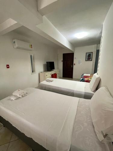 a room with two beds in a room at Pousada Beijos y Abraços in Natal