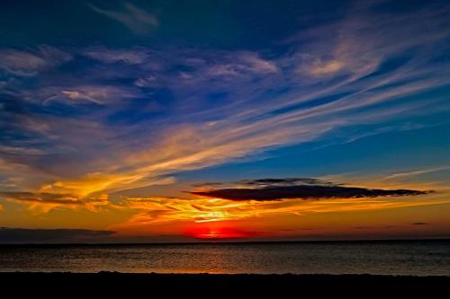 a sunset over the ocean with the sun setting at Barracuda #2B-CAC in Buxton
