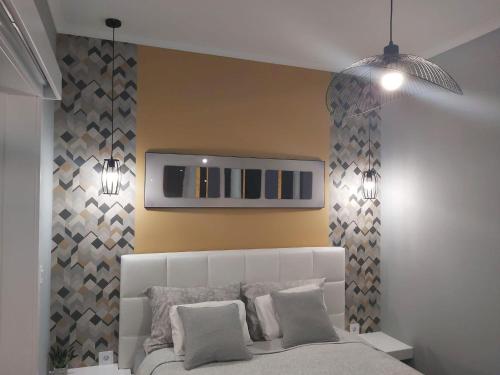 a bedroom with a bed and a tv on the wall at Apartman Golden in Senta