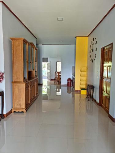 a large room with wooden cabinets and chairs at Puree Poolvilla Sattahip in Sattahip