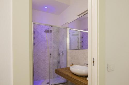 a bathroom with a sink and a shower at Relais Vittorio Veneto - Luxotel & Apartotel in Salerno
