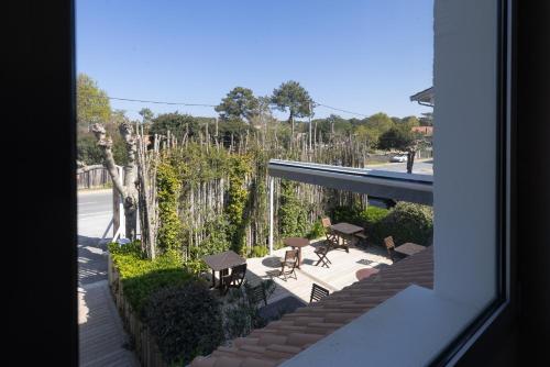 a view of a patio from a window of a house at La Frégate in Cap-Ferret