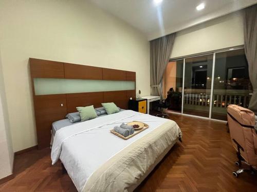 a bedroom with a large bed and a large window at 2Beds Seaview Straits Quay comes with Carpark and Hothub in Bagan Jermal