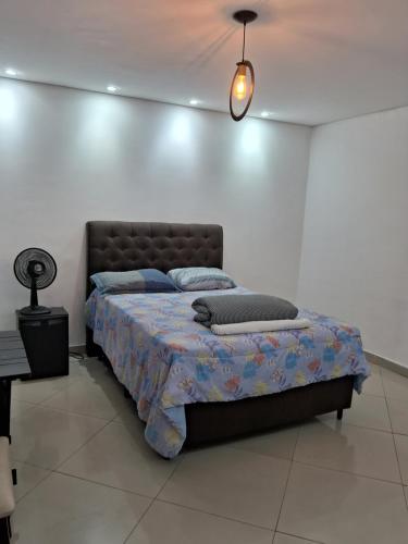 グアルーリョスにあるKitnet Suite próxima aeroportoe Guarulhosの白い部屋のベッドルーム1室(ベッド1台付)