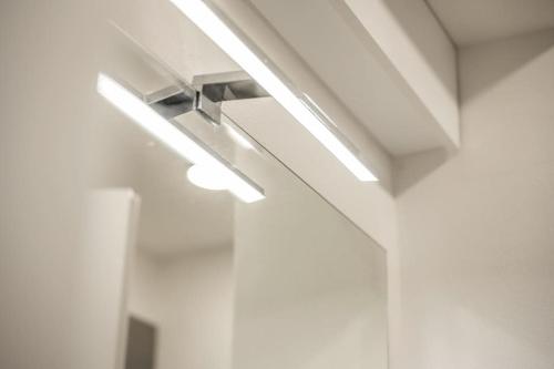 a row of lights on a ceiling in a room at [Old Town] Via Marsala Apartment in Bologna