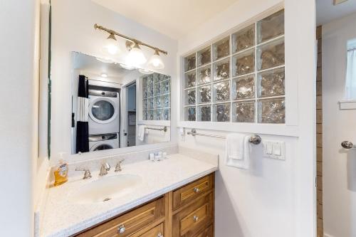 a bathroom with a sink and a microwave at Song of the Sea in Lincoln Beach