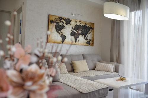 a living room with a couch and a map on the wall at Gold Gondola Premium Apartments in Ribnica