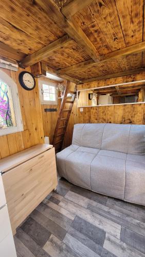 a bedroom with a bed and a clock in a room at Mon pti paradis in Lunel