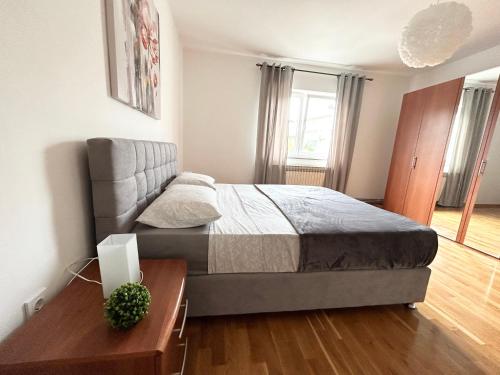 a bedroom with a bed and a wooden table at Apartment Flora in Pula