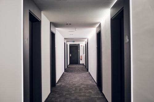 a hallway with black and white walls and a long corridor at Hotel Meksiko in Ljubljana