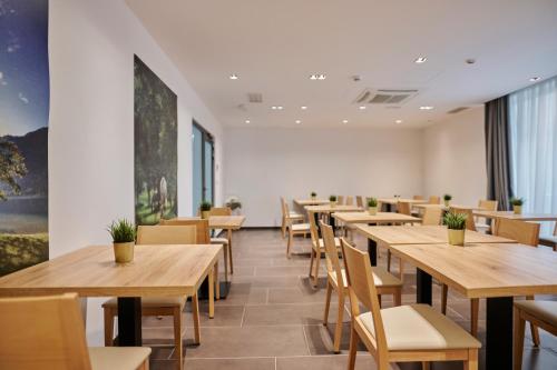 a dining room with wooden tables and chairs at Hotel Meksiko in Ljubljana