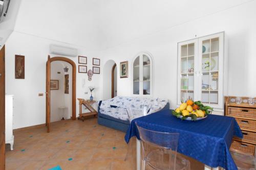 a living room with a table with a bowl of fruit on it at Estate4home - Angolo di Paradiso in Positano