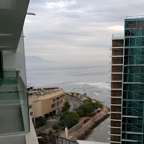 a view of the ocean from the balcony of a building at Hotel Alto Antofagasta in Antofagasta