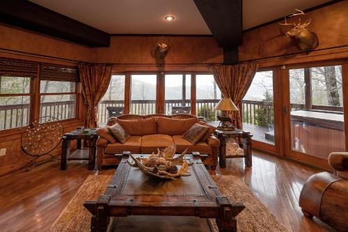 a living room with a couch and a table at MoonShadow Lakeview Cabin-3 Story Nantahala Lake in Topton