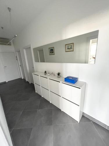 a white room with a counter and a mirror at Apartment Flora in Pula