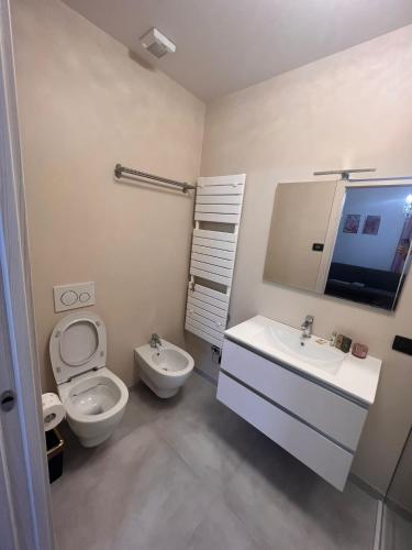 a bathroom with a toilet and a sink and a mirror at Casa Adriana in Rezzato
